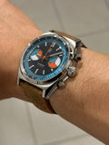 Blue skipper dial on matching brown distressed leather with orange stitch strap